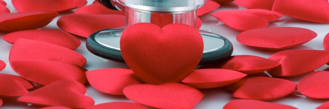 a stethoscope on top of a pile of red hearts